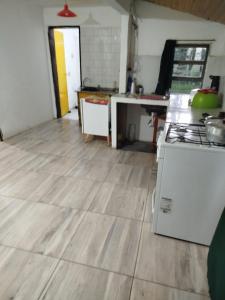 a kitchen with a wooden floor and a stove at Cabañas Jardín del Neuquén in Huinganco
