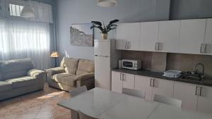 a kitchen and living room with a couch and a table at Casa Naihu in La Listada