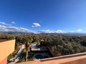 a view from the balcony of a house with a swimming pool at Villa isouktan in Sbiti