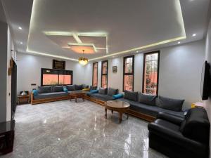 a living room with couches and a flat screen tv at Villa isouktan in Sbiti