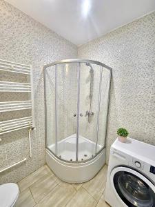 a shower in a bathroom with a washing machine at Marconi Premium Apartments in Mamaia +137 photos