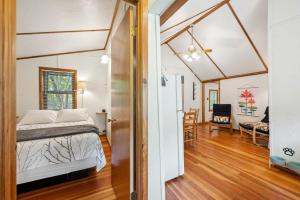 a bedroom with a bed and a dining room at Fish Creek Cottages in Fish Creek