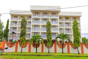 a building with palm trees in front of it at Raya Resort Nyali in Mombasa