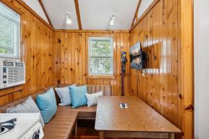 a room with a couch in a wooden wall at Fish Creek Cottages in Fish Creek