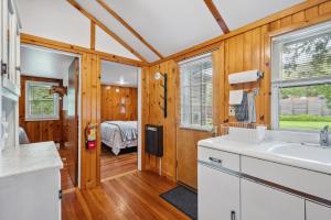 a kitchen with a sink and a bedroom at Fish Creek Cottages in Fish Creek +78 photos