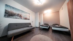 a living room with two beds and a couch at FlexHome Gemütliche Ferienwohnung in Lippstadt