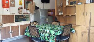a kitchen with a table and chairs and a refrigerator at La Marita in Gualeguay