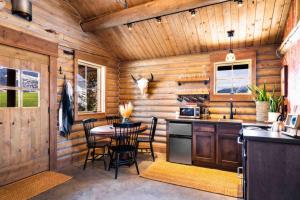 a kitchen with wooden walls and a table and chairs at Copper Rose Ranch in Livingston +61 photos
