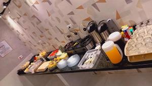 a shelf with a bunch of food on it at Hotel Estação - Osasco in Osasco