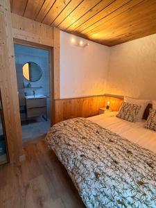 a bedroom with a bed with a wooden ceiling at Chalet d'Honneur in Chamonix +12 photos