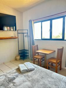 a bedroom with a bed and a table and chairs at Incredible 360 views 5 min from downtown in Tepoztlán +42 photos
