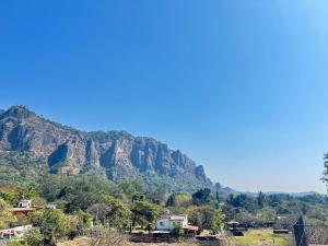 a view of a mountain with houses and trees at Incredible 360 views 5 min from downtown in Tepoztlán