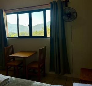 a room with a table and chairs and a window at Incredible 360 views 5 min from downtown in Tepoztlán