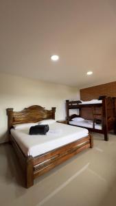 two beds in a room with two bunk beds at Hotel Campestre San Fernando in La Paloma +54 photos