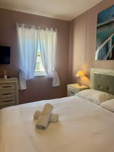 a bedroom with a bed with two towels on it at Europa Point Area Townhouse in Gibraltar