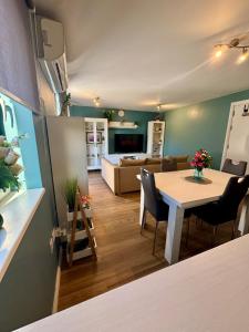 a kitchen and living room with a table and a couch at Europa Point Area Townhouse in Gibraltar