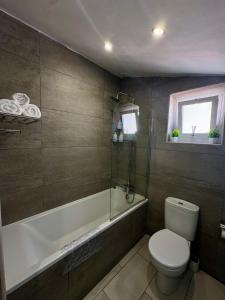 a bathroom with a toilet and a bath tub at Europa Point Area Townhouse in Gibraltar +19 photos