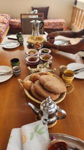 a wooden table with food on top of it at La Cabane Surf Lodge in Agadir