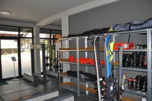 a room with a bunch of skis on shelves at Bela Reka 204 in Brzeće