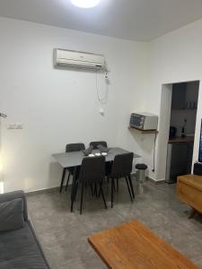 a dining room with a table and chairs in a room at SIMA Suite Unit 1 in Ashdod