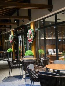 an outdoor patio with tables and chairs and plants at Bela Reka 204 in Brzeće