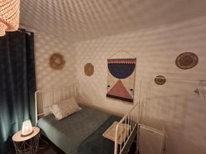 a small bedroom with a bed and a phone on the wall at Refúgio de Arez-Alojamento Local in Arez