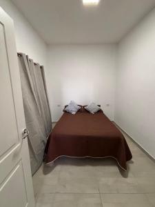 a bedroom with a bed in a white room at Casa Susana in Jesús María