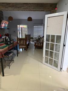 a living room with a table and chairs and a door at Casa Susana in Jesús María