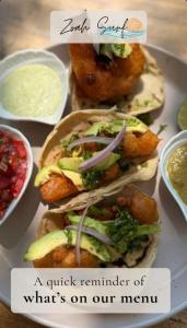 a plate of food with sandwiches and other foods at Zoah Surf Hotel, El Paredón in El Paredón Buena Vista
