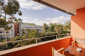 a balcony with a view of palm trees and buildings at Hotel Casarose - Cannes Mandelieu in Mandelieu-La Napoule