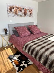 a bedroom with a bed with a cow print on the wall at Chalet Les Marmouzets in Gryon +8 photos