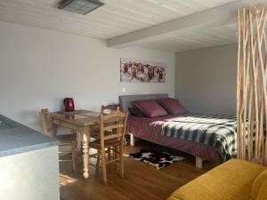a bedroom with a bed and a table and a desk at Chalet Les Marmouzets in Gryon