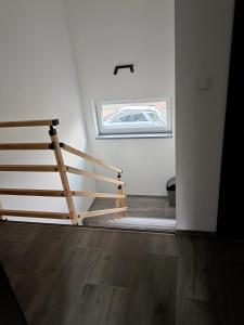 a wooden staircase in a room with a window at Przystań w górskim Raju in Bolesławów