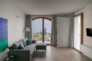 a living room with a couch and a large window at Marion's Apartment in Riva di Solto +22 photos