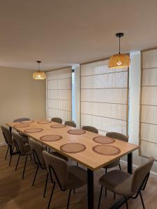 a conference room with a large wooden table and chairs at Amavilla Hotel in Telavi
