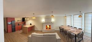 a kitchen and dining room with a table and a fireplace at Amavilla Hotel in Telavi