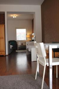 a living room with a bed and a table and chair at Kukucinova Apartments in Bratislava +14 photos