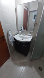 a bathroom with a sink and a mirror at גאון מול המדבר in Arad