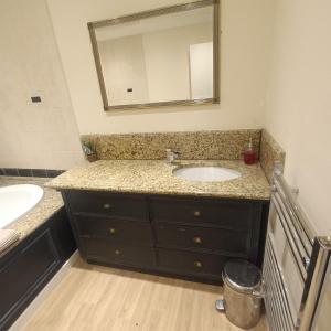 a bathroom with a sink and a mirror at Foxy stays in Tanfield +19 photos