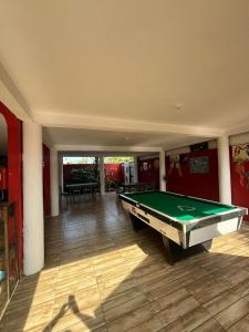 a living room with a pool table in it at Pousada NativaMar in Guaratuba