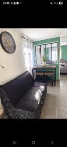 a room with a bed and a table in it at La jonquiere etablisement climatisé in Landouzy-la-Cour