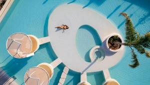 an overhead view of a person swimming in a pool at Enorme Santanna Island - Premium All Inclusive in Sisi +87 photos