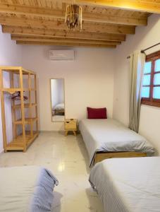 a bedroom with two beds and a mirror at Blue Villa in Lighthouse in Dahab