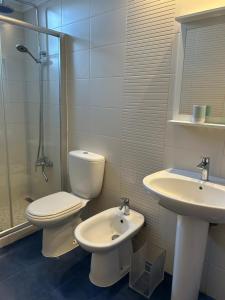 a bathroom with a toilet and a sink and a shower at Casa da Avó - Vila do Porto in Vila do Porto +37 photos