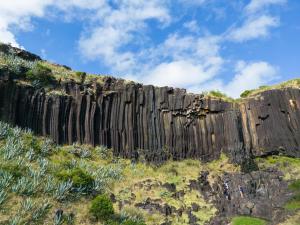 a large rock wall on the side of a hill at Casa da Avó - Vila do Porto in Vila do Porto
