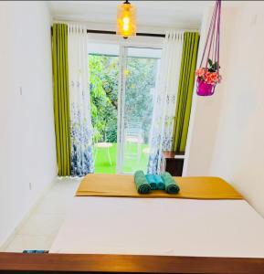 a bedroom with a bed with a window and two towels at 35-B-5 Kandy in Kandy +27 photos
