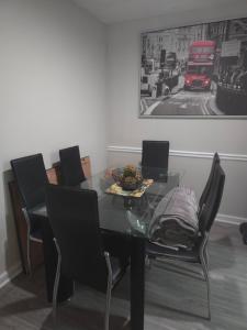 a dining room with a glass table and chairs at The Monthly stay Apartment for 8, pool and grill in Greensboro +9 photos