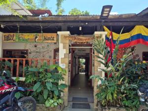 an entrance to a building with a flag and plants at Hotel Eco Point in Minca