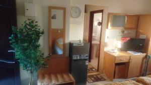 a small kitchen with a refrigerator in a room at EL Salam in Hotel Apartment 6 in Sharjah