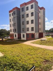 a large building in a park with a grass field at Pearl Studio in Machakos +5 photos